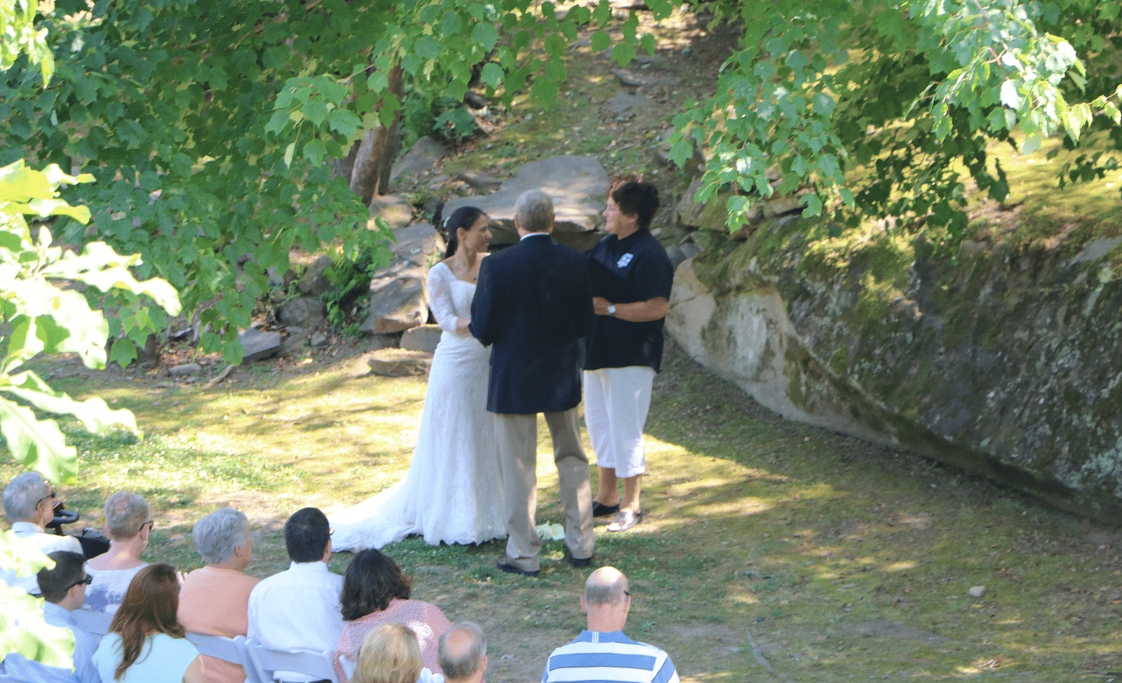 a couple getting married with the guests sitting in front of them witnessing the matrimony - Historic Tapoco Lodge