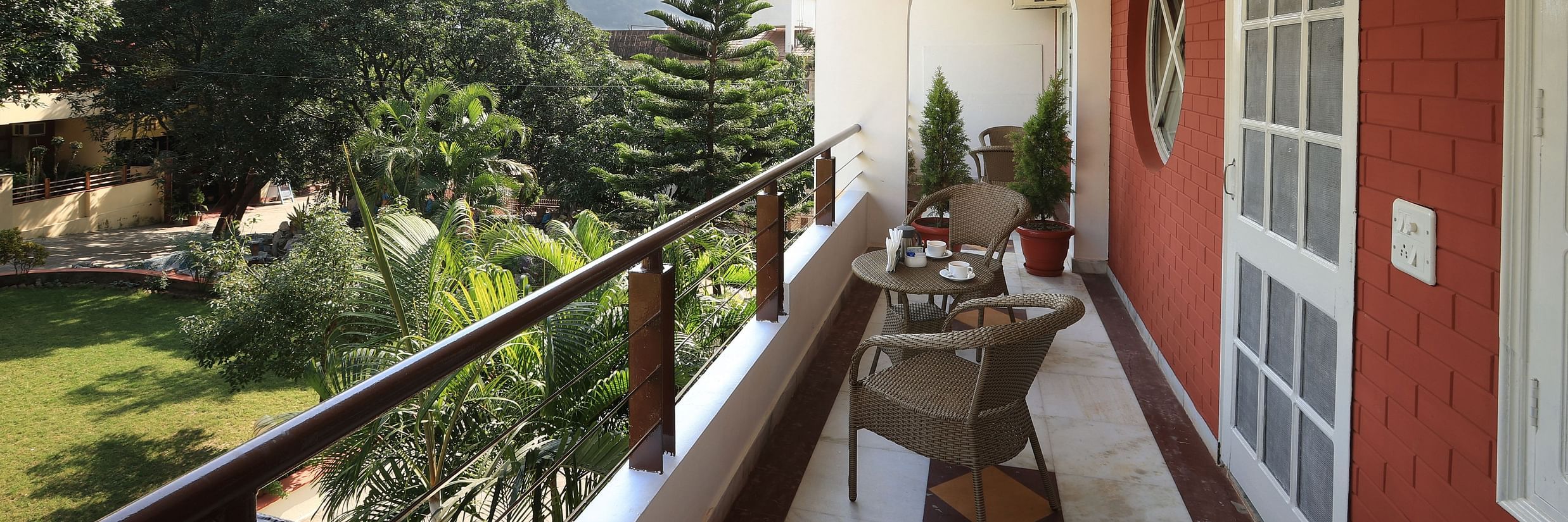 Super Deluxe Room balcony offers a view of the surrounding greenery - Lamrin Boutique Cottages Rishikesh