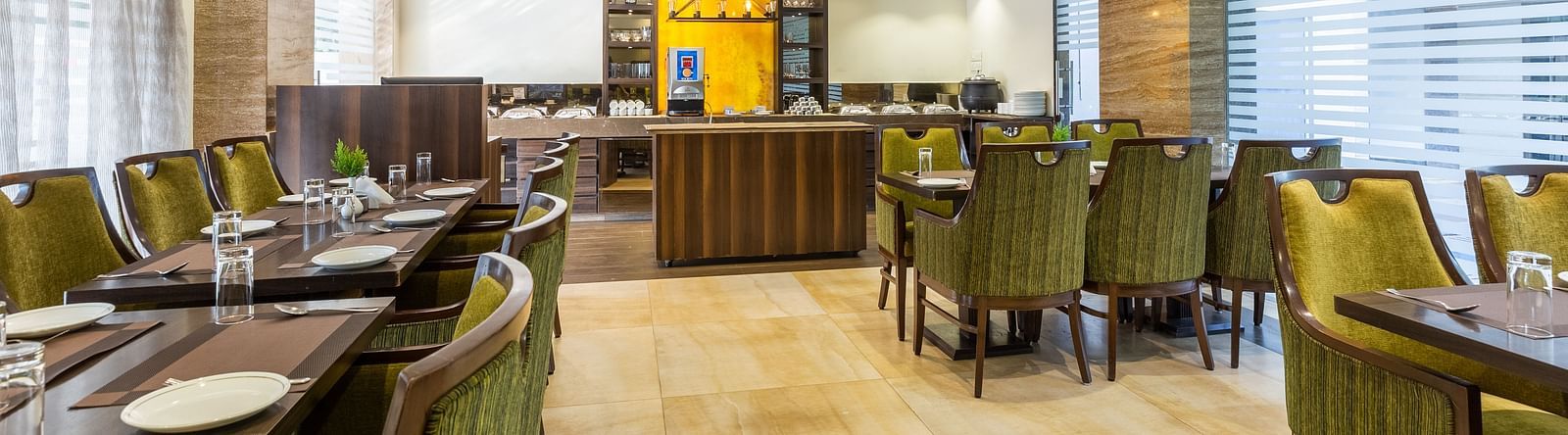 Image of a dining area with tables and chairs at Calux Grand Inn, Calangute.