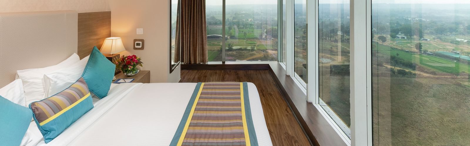 A plushy bed with a view at golden suites