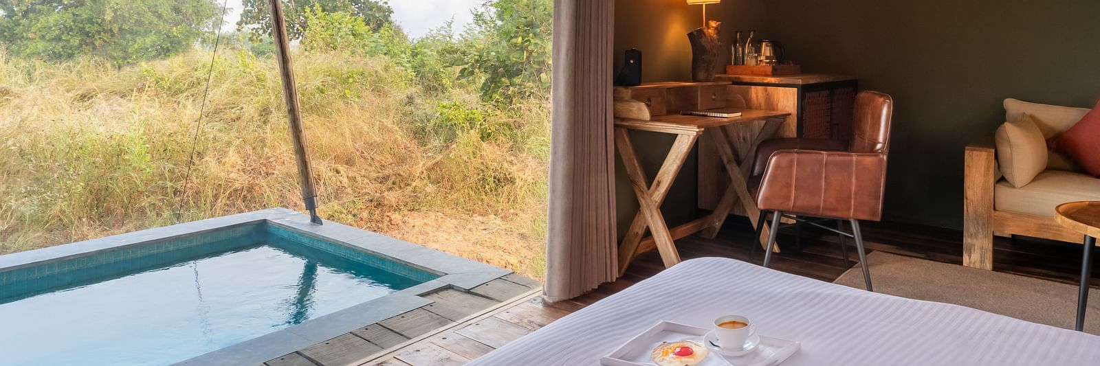 A view of a small pool from inside of a tent at Trees N Tigers, Tadoba.