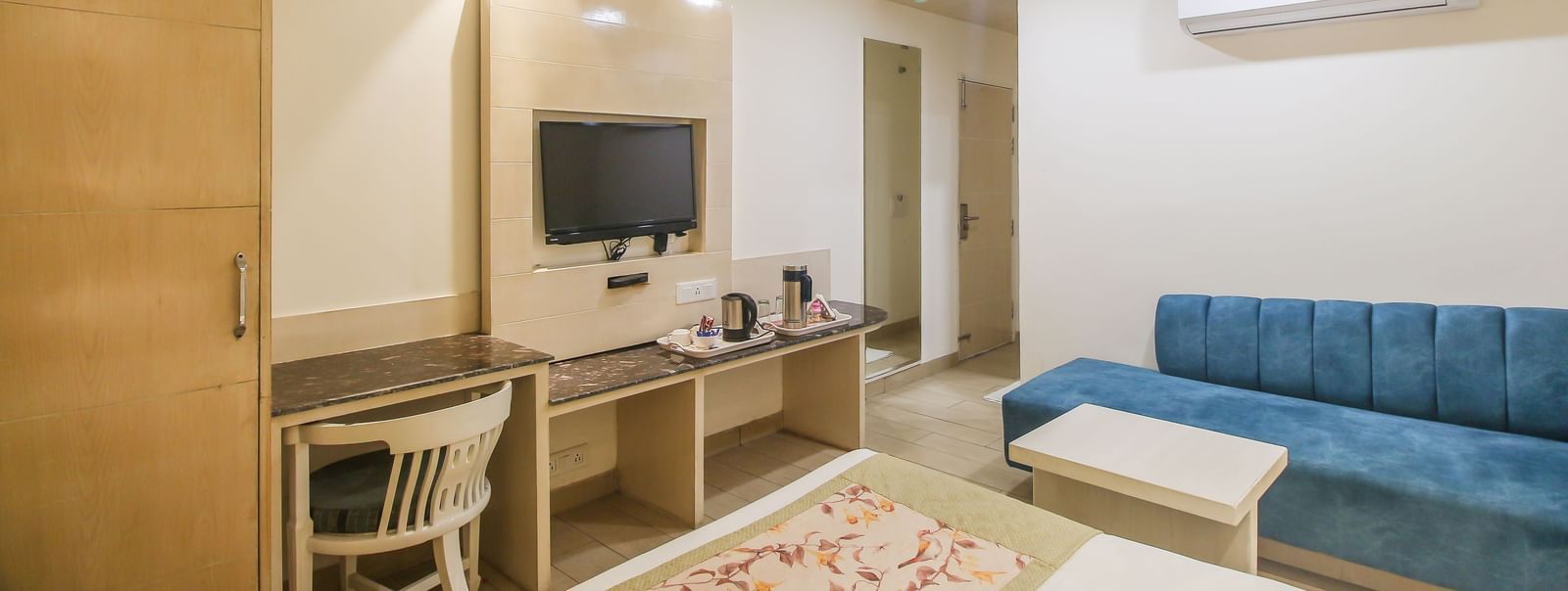 Room with desk, TV, and seating area at Hotel Diamond Plaza, Chandigarh
