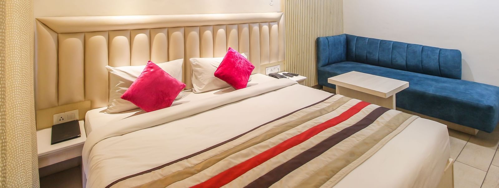Well-appointed guest room with modern furnishings at Hotel Diamond Plaza, Chandigarh