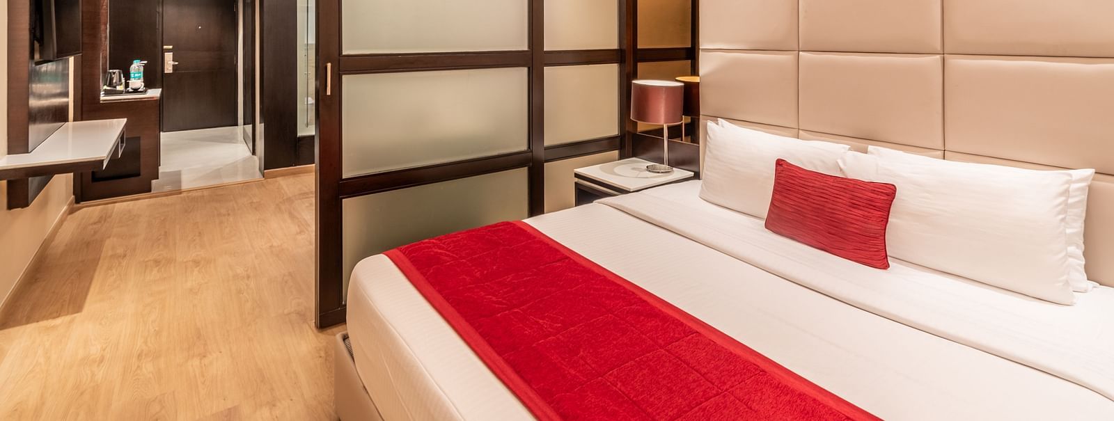 Fortuna suite view showing bed, wardrobe, and seating arrangement- TGI Grand Fortuna, Krishnagiri Main Road, Hosur