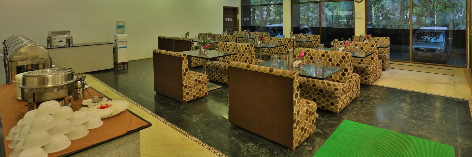 A large dining area with various seating areas, including sofas and low tables, and warm lighting - Retreat Heritage, Lonavala