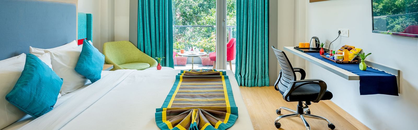 An image of a bedroom with balcony | Inde Hotel Golf Course Extension