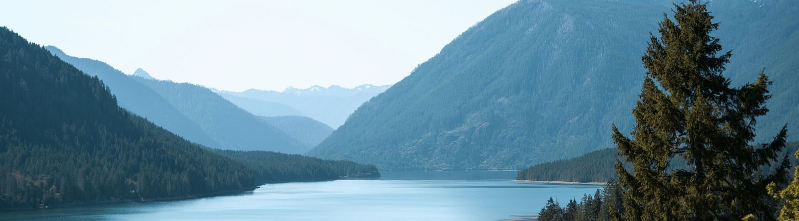 Scenic view of the lake surrounded by hills.