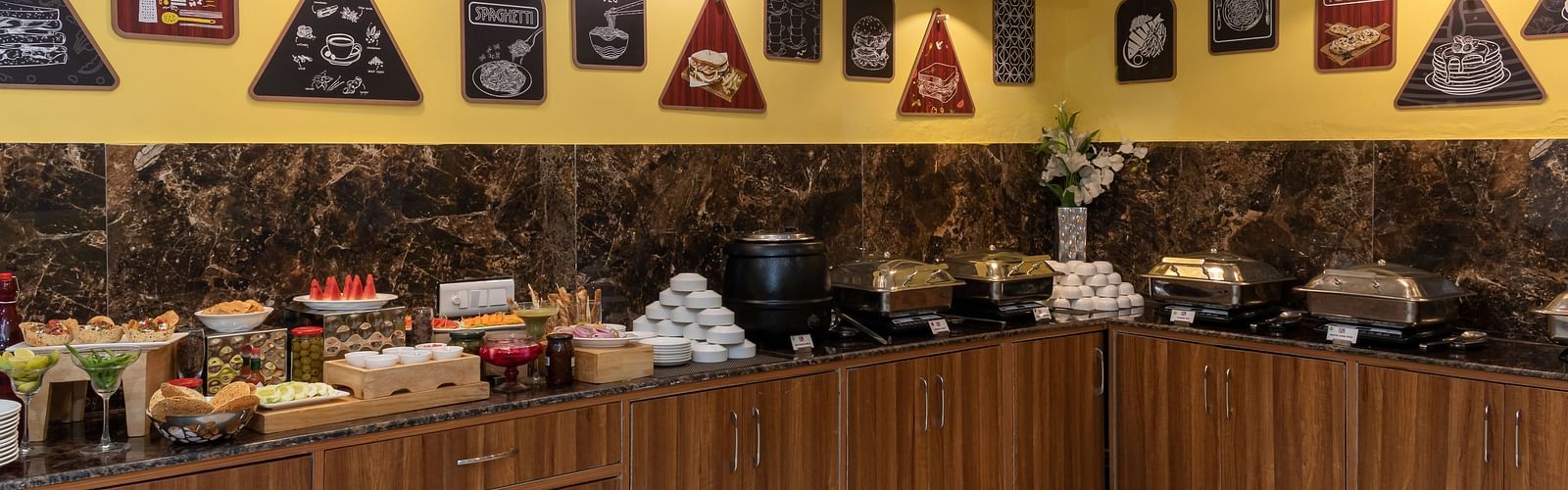 A colourful buffet display, featuring a variety of dishes in a contemporary restaurant setting | Inde Hotel Cyber City 