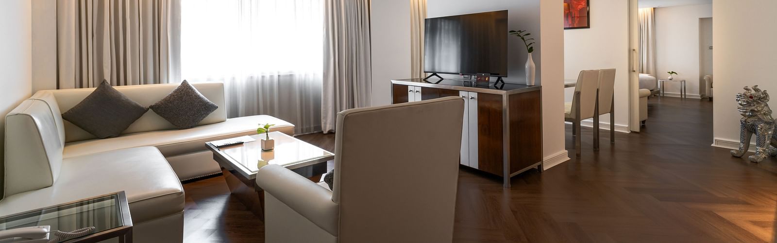 An overview of the living room with sofas and table in view - Night Hotel Bangkok.