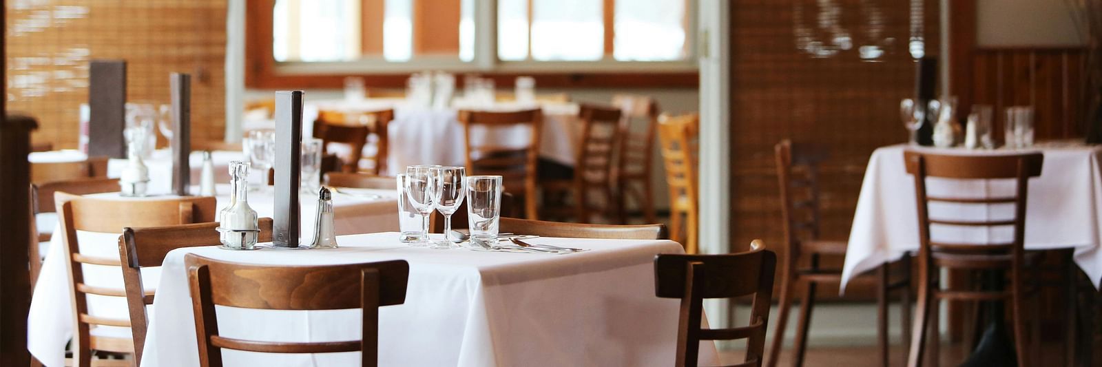 dining area with comfortable seating, culinary delights neatly arranged on the table, and a warm, inviting ambience