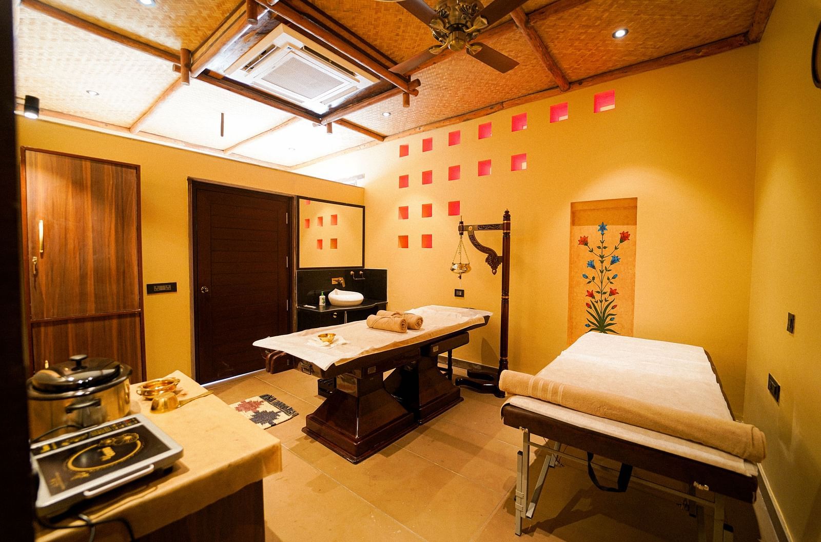 View of a calming spa treatment room with warm lighting at Aamaghati Wildlife Resort.