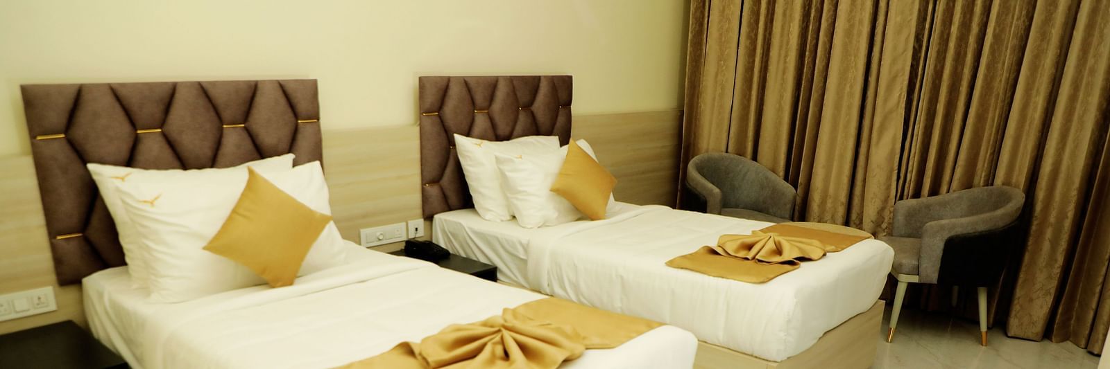 Twin bed deluxe room at Town Square Suites featuring elegant furnishings and cozy ambiance