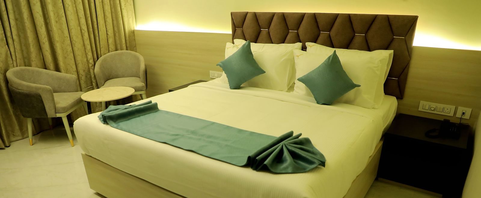 Luxurious king-size bedroom at Town Square Suites with modern decor and ambient lighting
