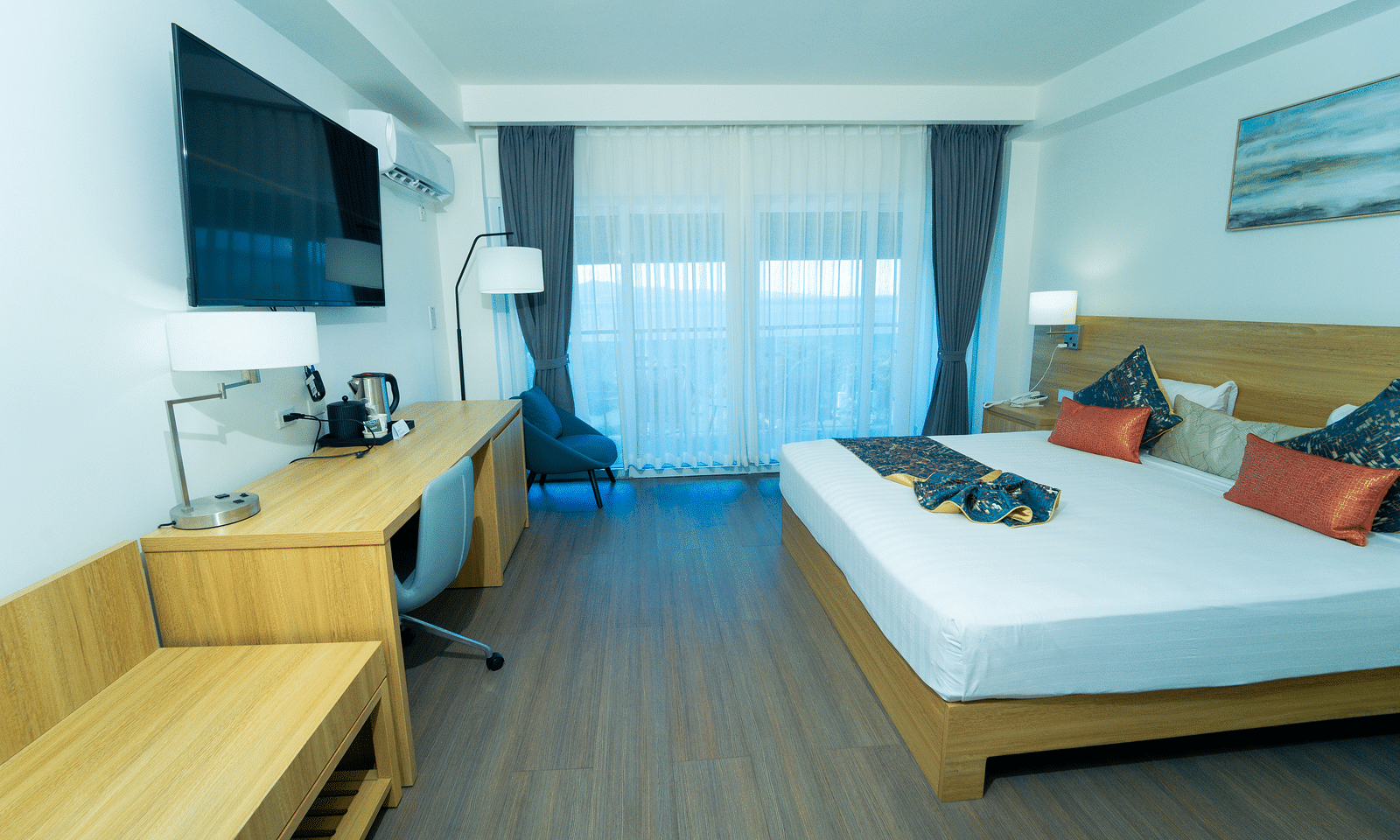 An image of a hotel room in Montego Bay with a king size bed and a wall mounted television - Hotel 39, Jamaica (Montego Bay)