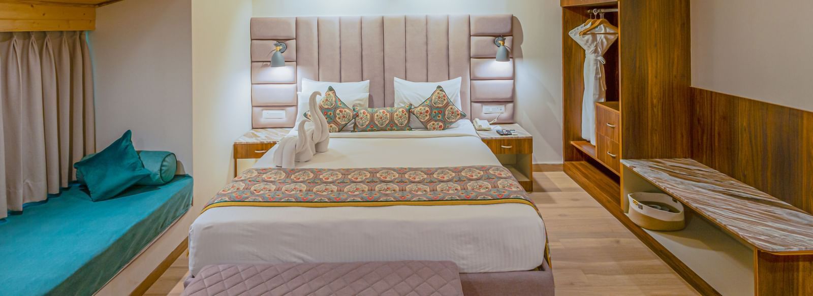 Sajjan Villa with Jacuzzi at Bamboo Saa Resort and Spa, Udaipur featuring a double size bed, a bedside table, a small bed near the window, a wardrobe, a ceiling fan, and a workstation.