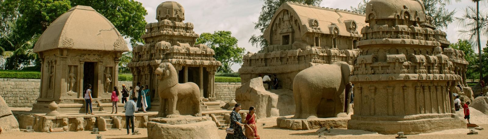 Ancient stone sculptures surrounded by lush greenery