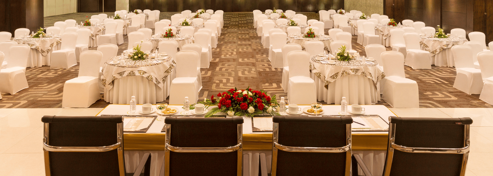 Lavish indoor banquet hall decorated for an event at Narayani Heights Hotel & Resorts, Ahmedabad.