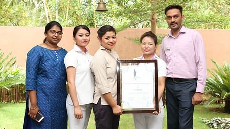 Staff showing their winning certificate.