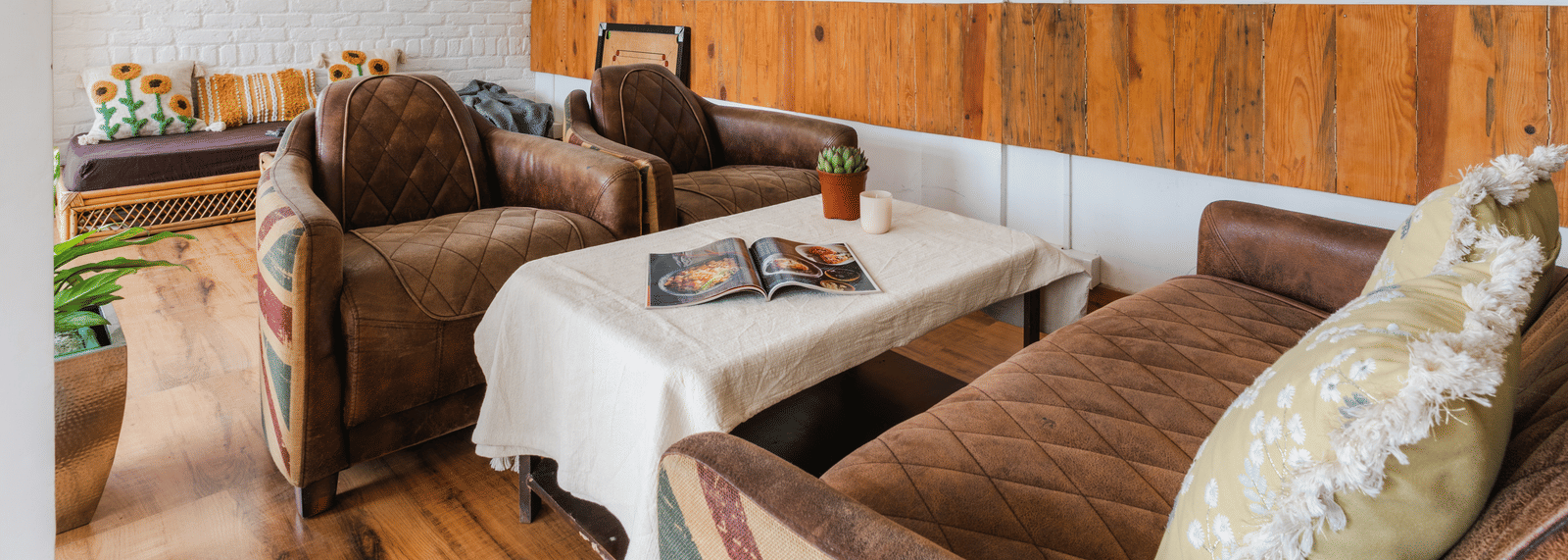 An indoor living area with a sofa and armchairs at Ziran Retreat.