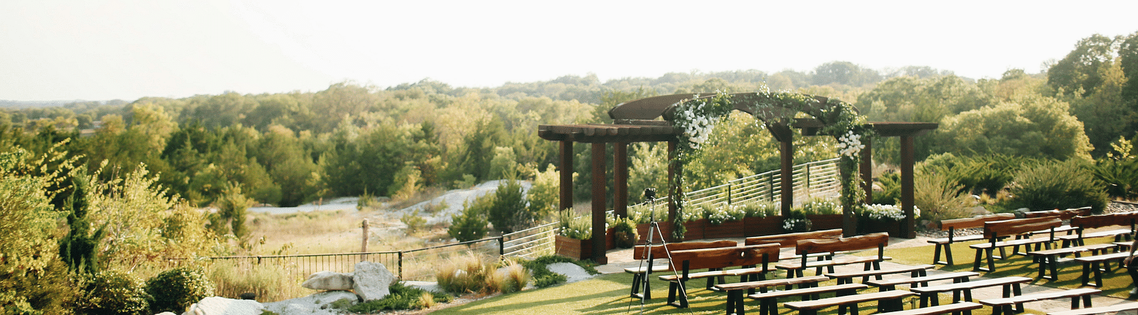 An aerial long shot of the wedding lawn, beautifully blanketed in lush greenery