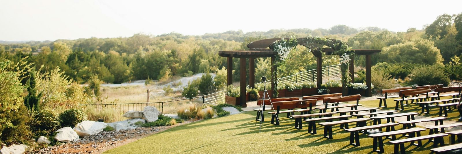 An aerial long shot of the wedding lawn, beautifully blanketed in lush greenery