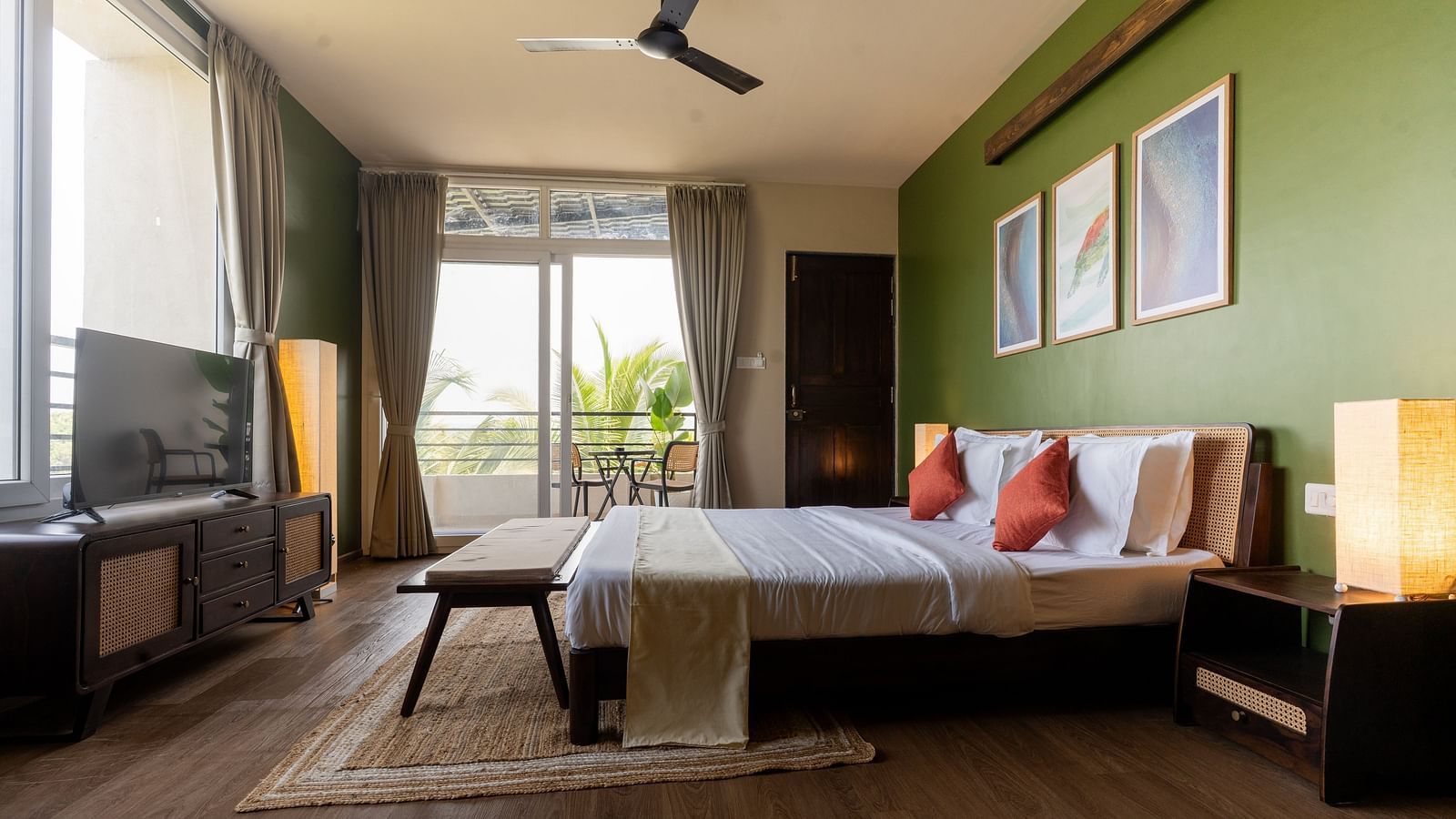 Spacious bedroom with natural lighting, modern decor, and a cosy seating area at Kssemya.