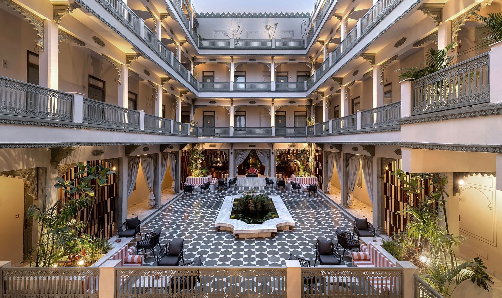 An overview of a courtyard with the inside of the building in view - Manuscript - Jhilwara Haveli, Udiapur