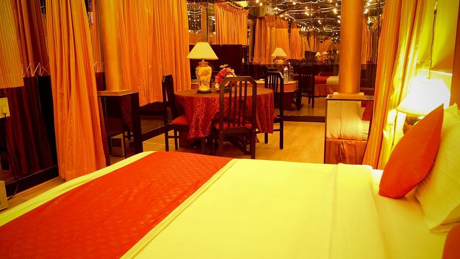  Hotel Yasodha Towers - Interior view of a bedroom featuring a bed with red and white coloured bed sheet and a table seen in the background 