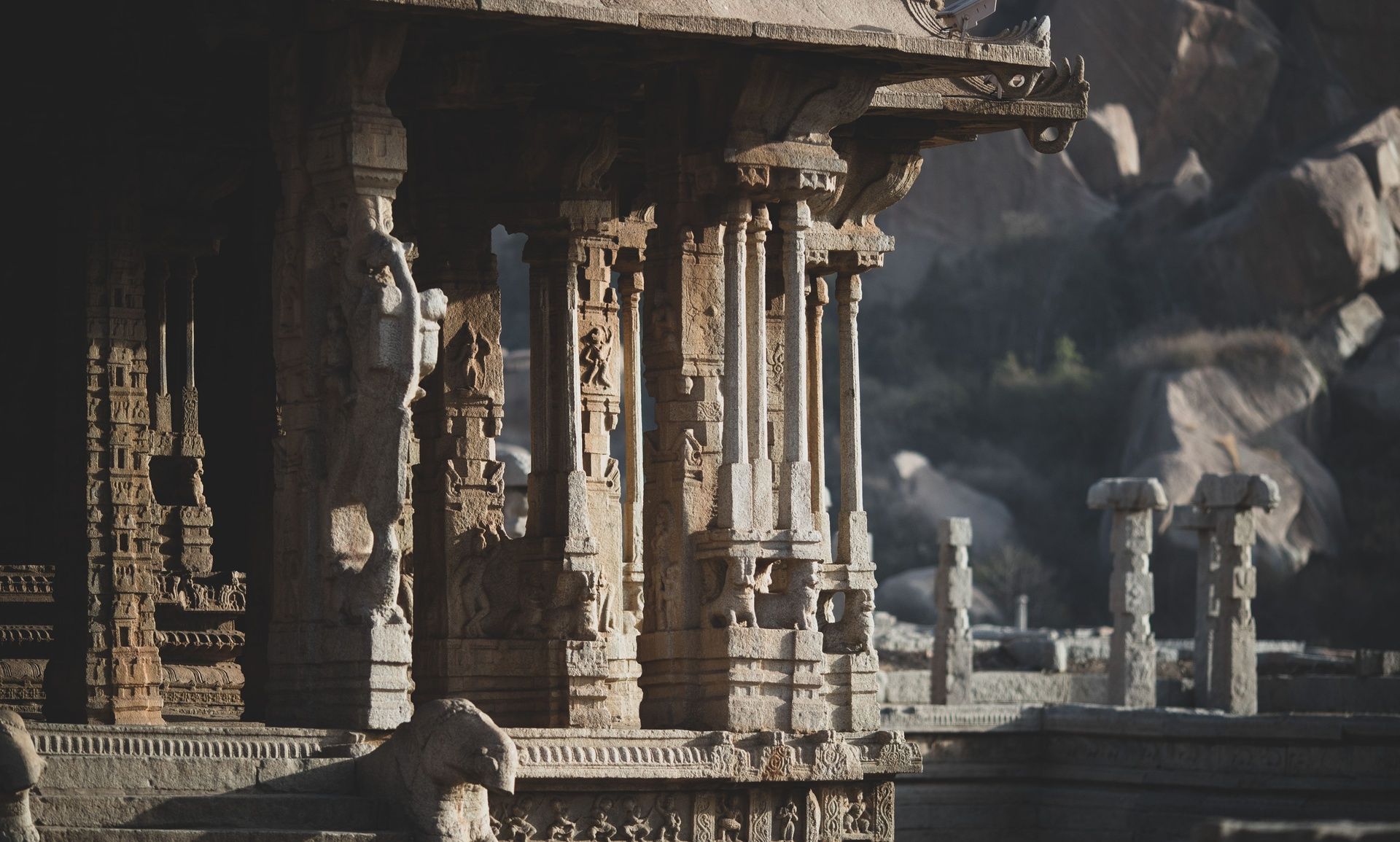 Ancient Hampi temple ruins with intricately carved pillars.