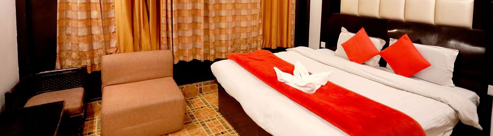 Image of a room with a bed and a sofa in front at Amara Hill Queen, Mussoorie.