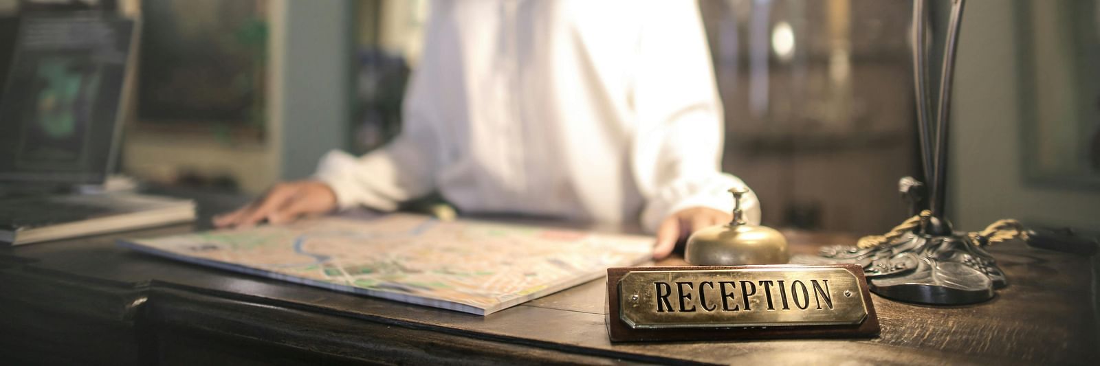 Image of a lady at the reception desk.
