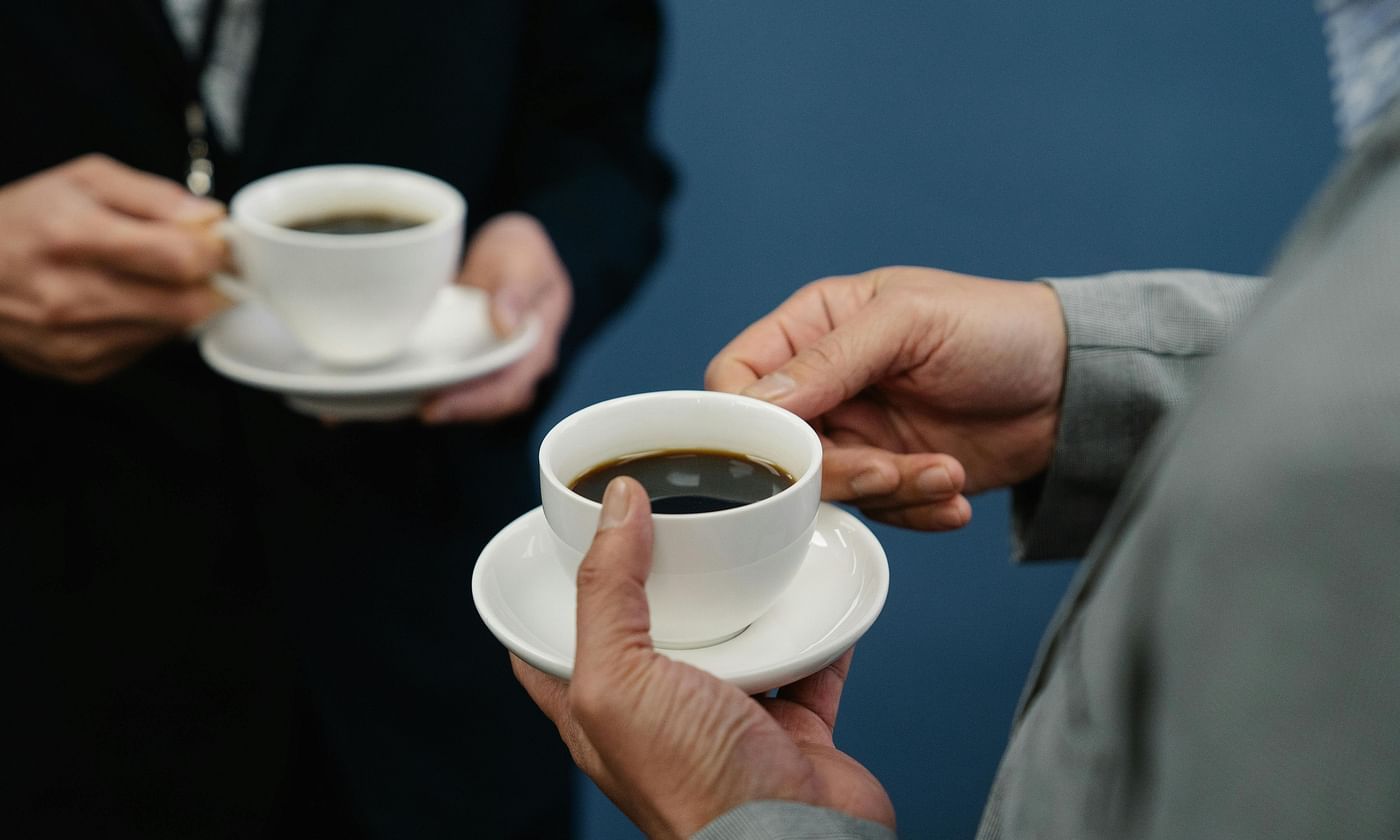 Business professionals enjoying coffee during a meeting