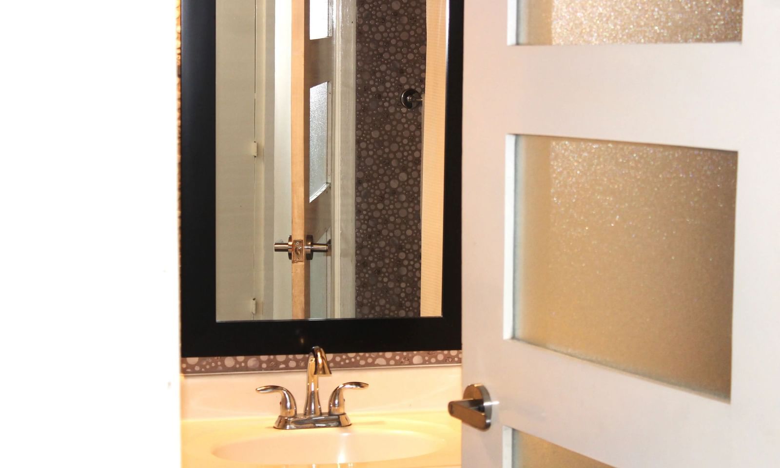 A bathroom vanity with a mirror and sink | Junior Suite | Altamont Court, Jamaica