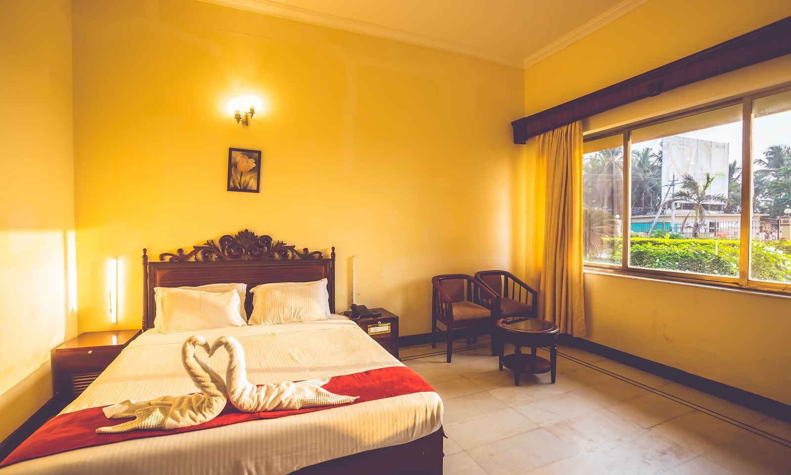 Premium Room at Paradise Isle Beach Resort, Udupi with a double bed and garden views from the window