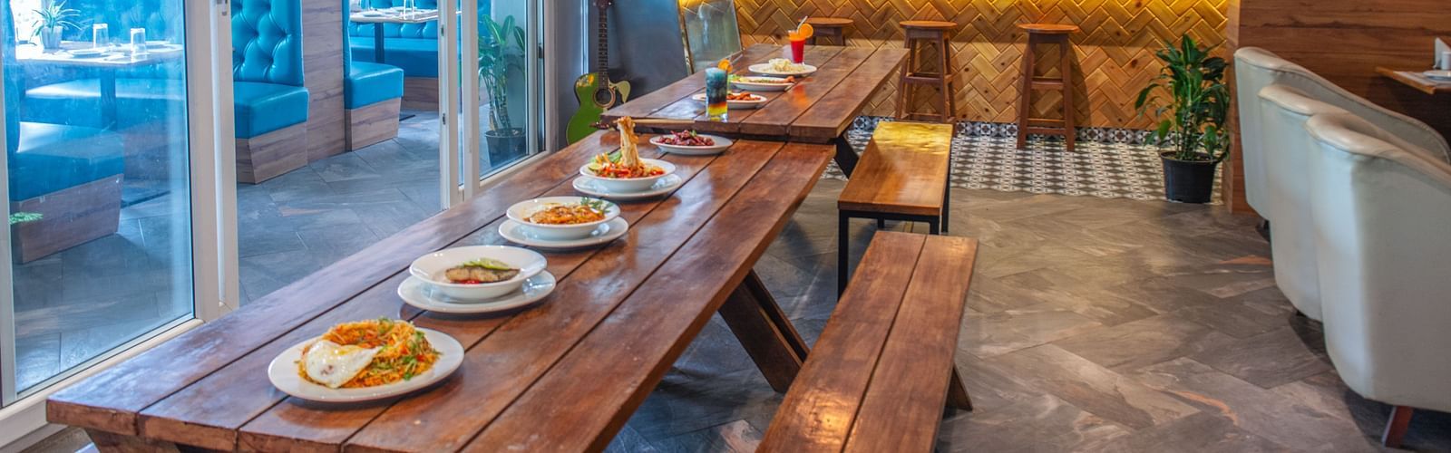 Image of a dining space space with a variety of food on a wooden table at  Avianna Ganagtok Resort and Spa
