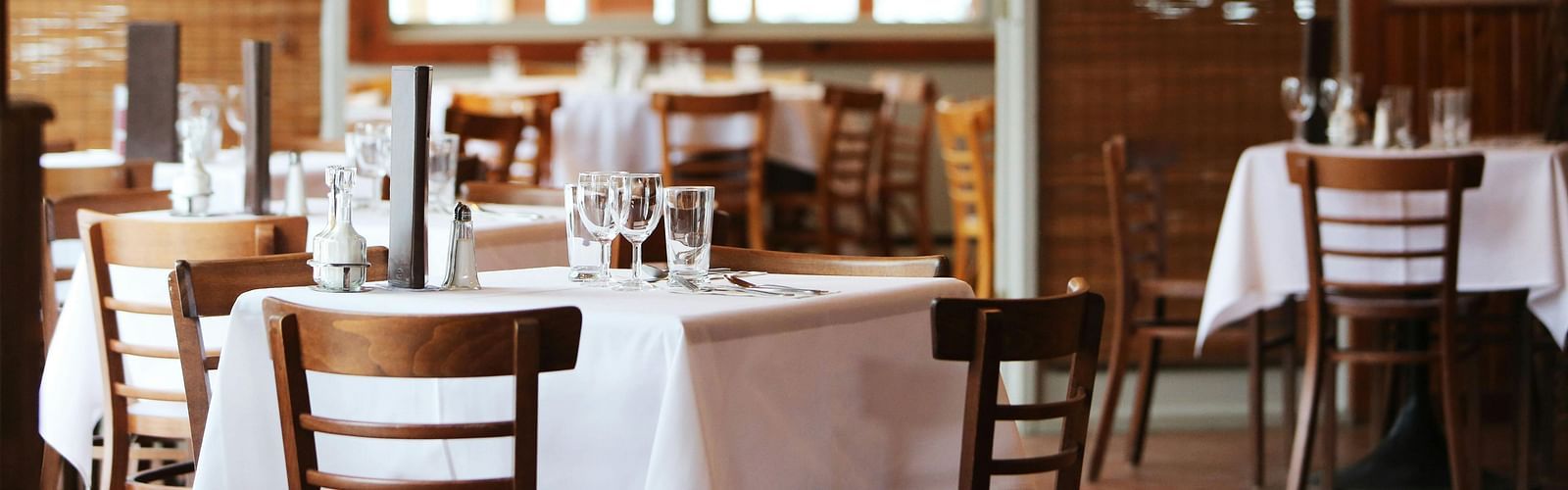 A dining area with comfortable seating, culinary delights neatly arranged on the table, and a warm, inviting ambiance