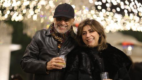 An image of  couple smiling and laughing together at an event at Heritage Village Resorts & Spa