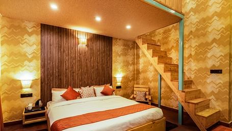 A room with a double bed and attic