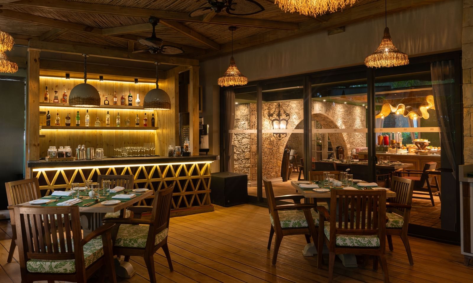 The indoor dining area of Mila Restaurant at The Evren, Vagator, with elegant lighting.