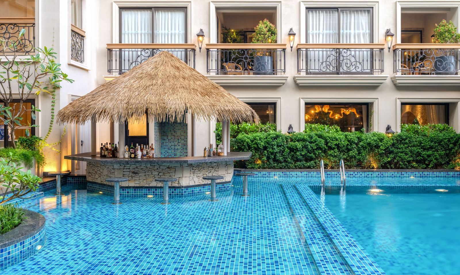 The Splash Pool Bar with calm waters in the swimming pool in the foreground at THe Evren, Vagator.