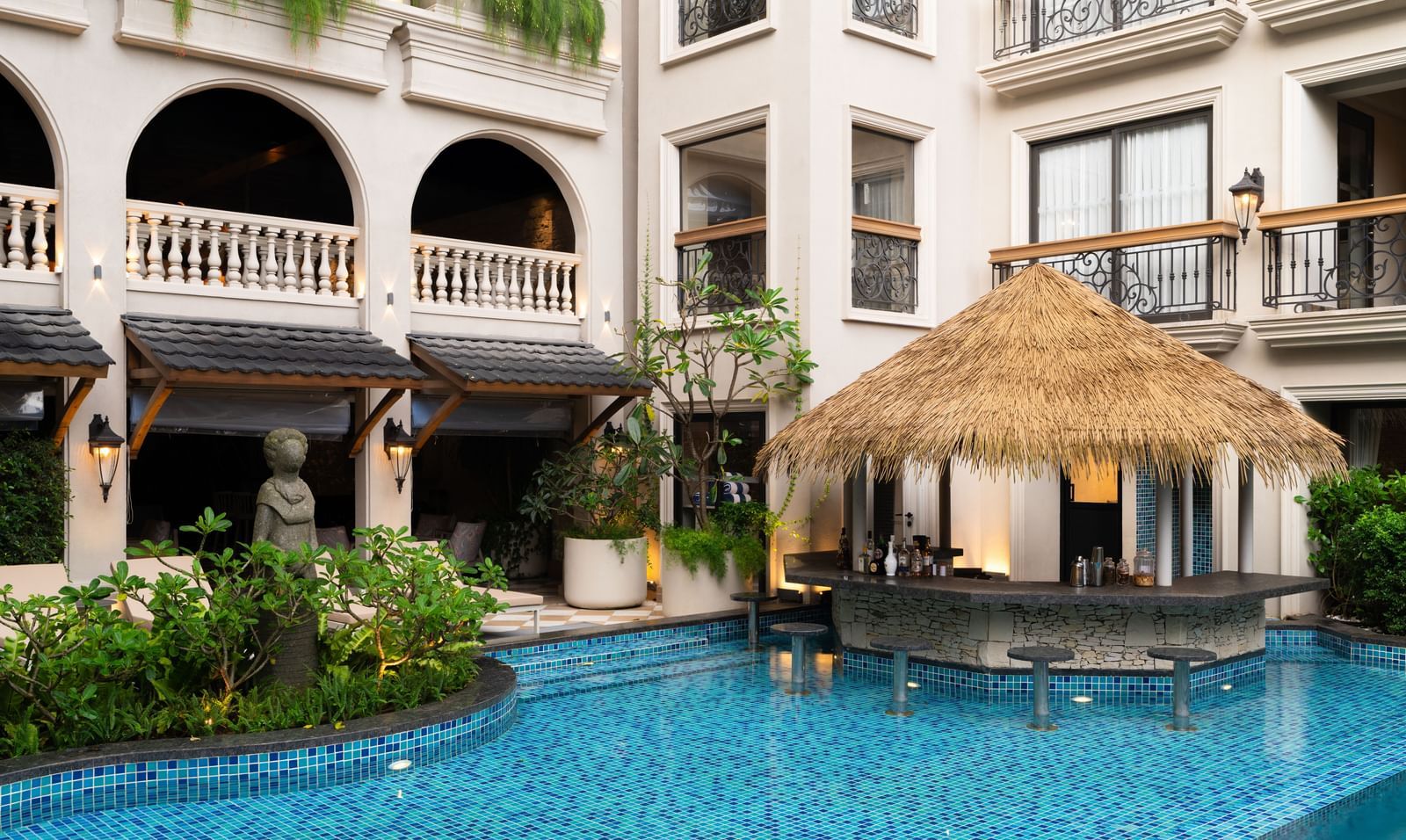 Side-view shot of the Splash Pool Bar with thatched roof above it at The Evren, Vagator.