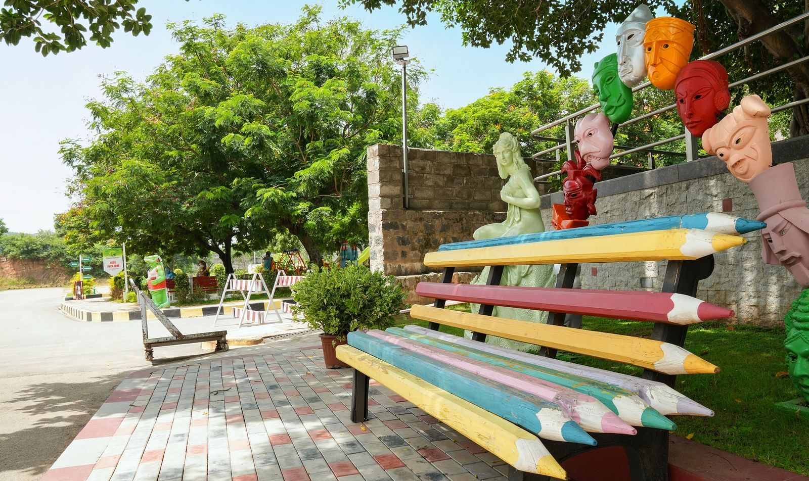 Pencil-shaped seats surrounded by trees at Greens Inn - Creative Seating in Hyderabad.