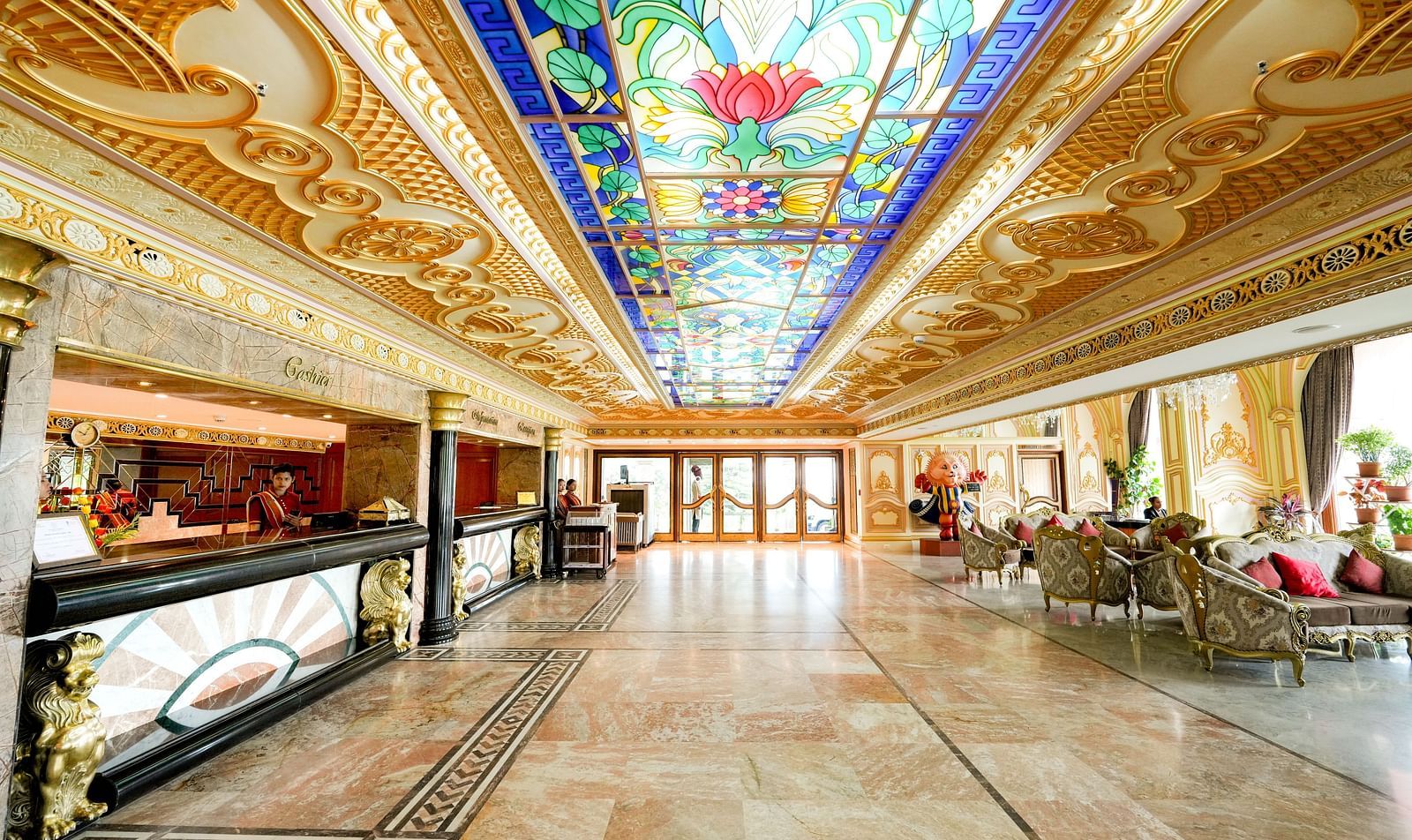 Seating area at Sitara Luxury Hotel in Hyderabad near Ramoji Film City with a sofa and painted ceilings