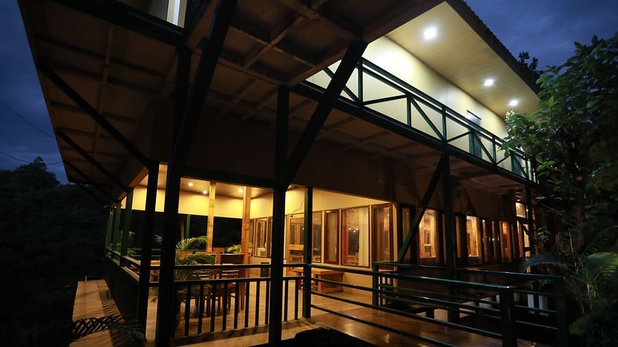 one of the cottages at The Sal Woods Forest Resort & Spa lit up at night