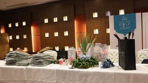 A table where several items are placed including packed suites, bouquets, small and cylindrical boxes, a bag, etc. at Heritage Village Resorts & Spa