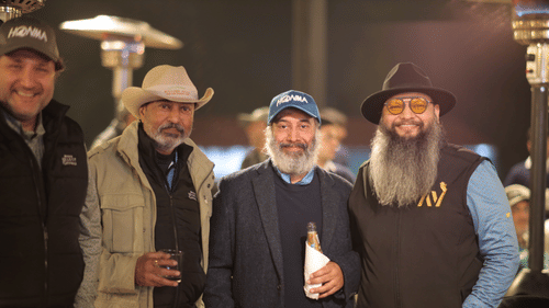 People standing together, facing the camera and holding drinks. - Heritage Village Resorts & Spa