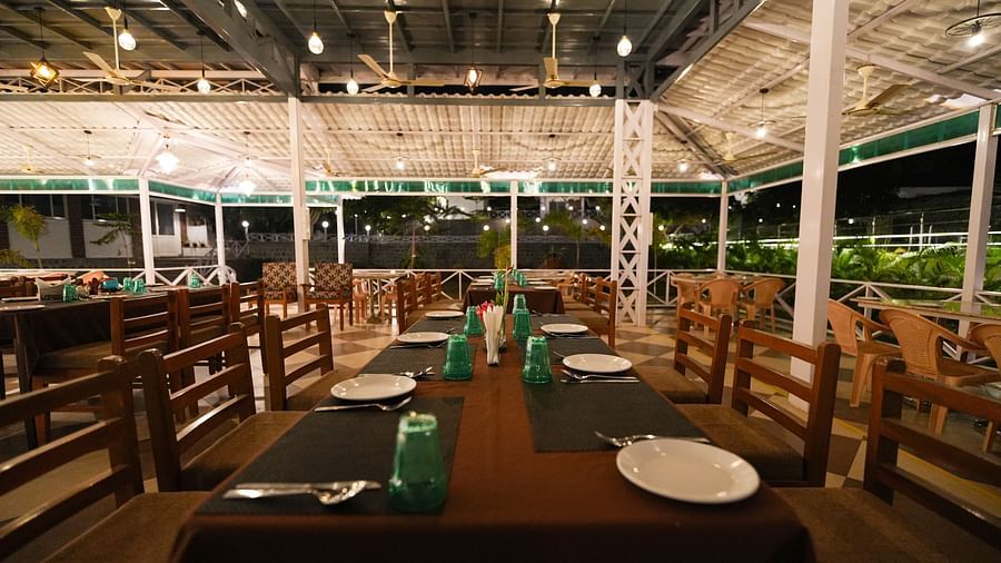 Picture featuring the restaurant, with dining tables arranged and brightly lit.