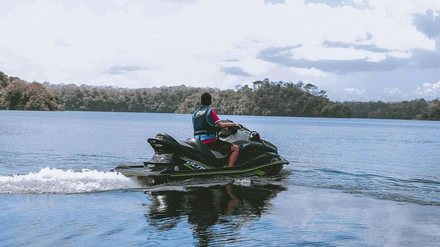 Man Riding Jetski on Body of Water