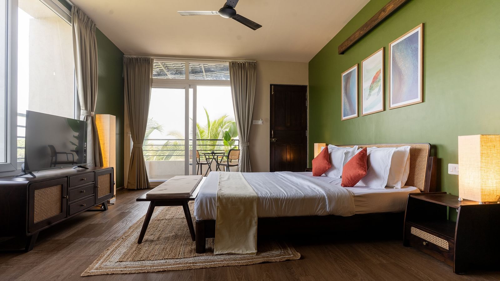 Spacious bedroom with natural lighting, modern decor, and a cosy seating area at Kssemya.