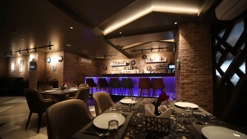 Seating arrangements inside the bar & restaurant with modern interiors - VITS Bharat Nanded